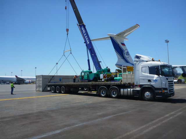 Truck loading freight from plane